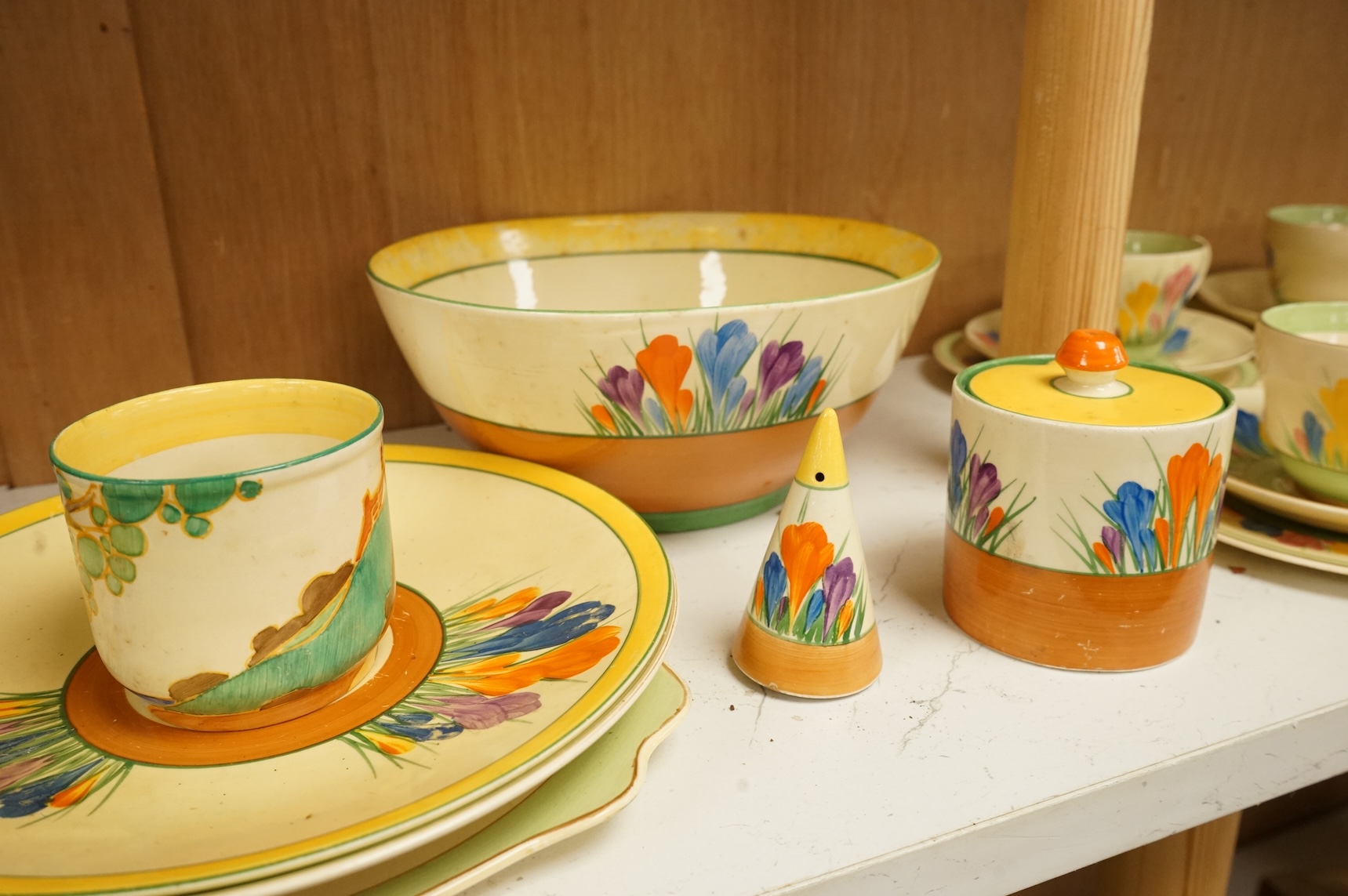 Collection of Clarice Cliff crocus pattern tea wares to include trios, milk jug, and a bowl, largest 22cm in diameter